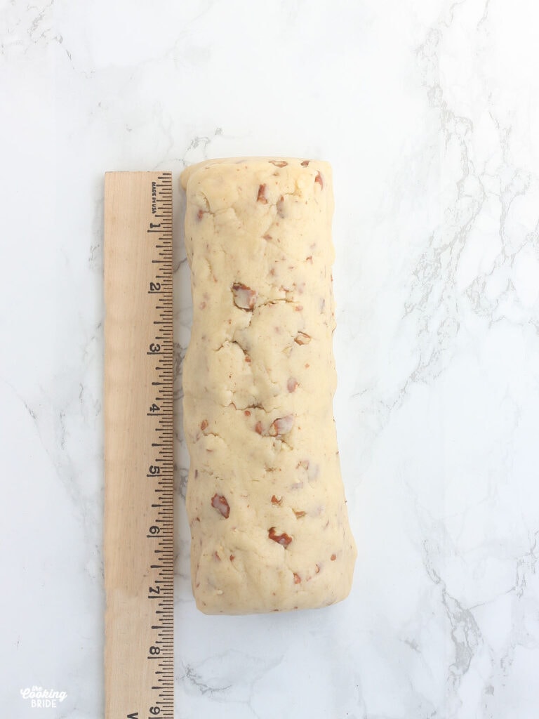 ruler showing the length of a log of cookie dough
