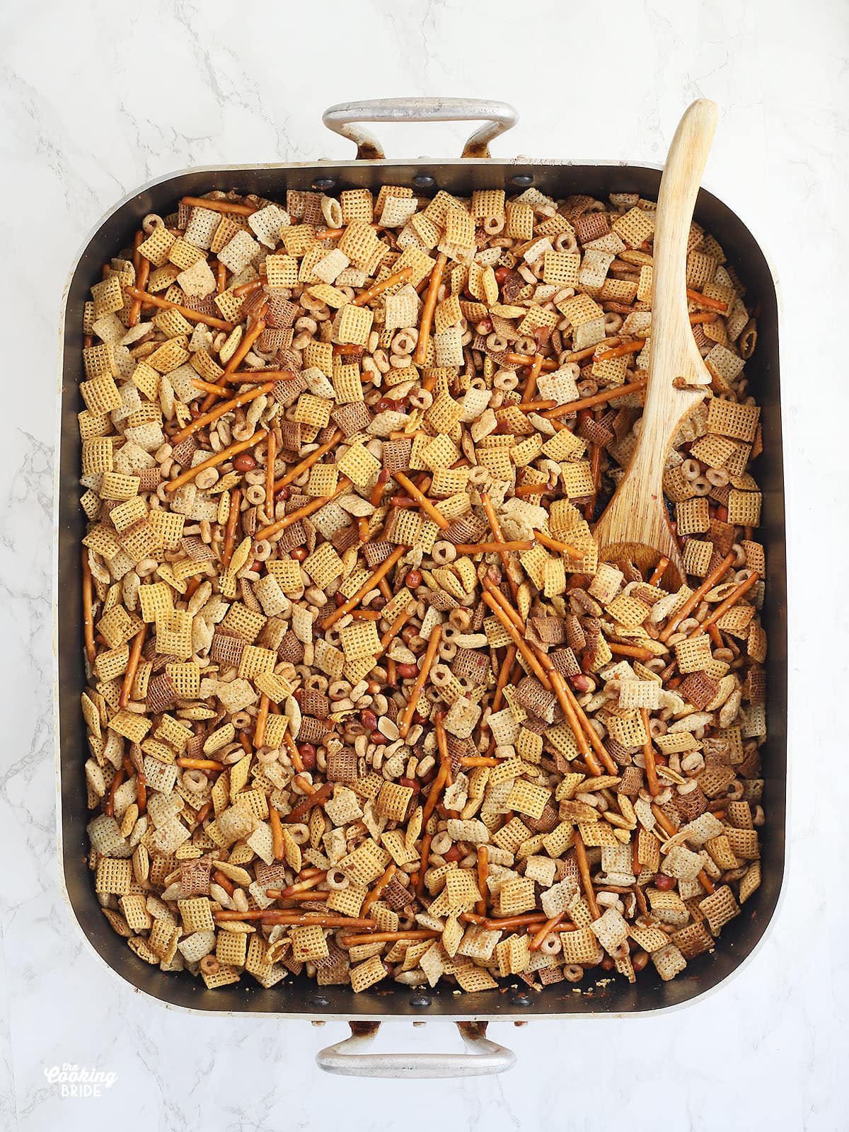 Chex mix ingredients in a large roasting pan
