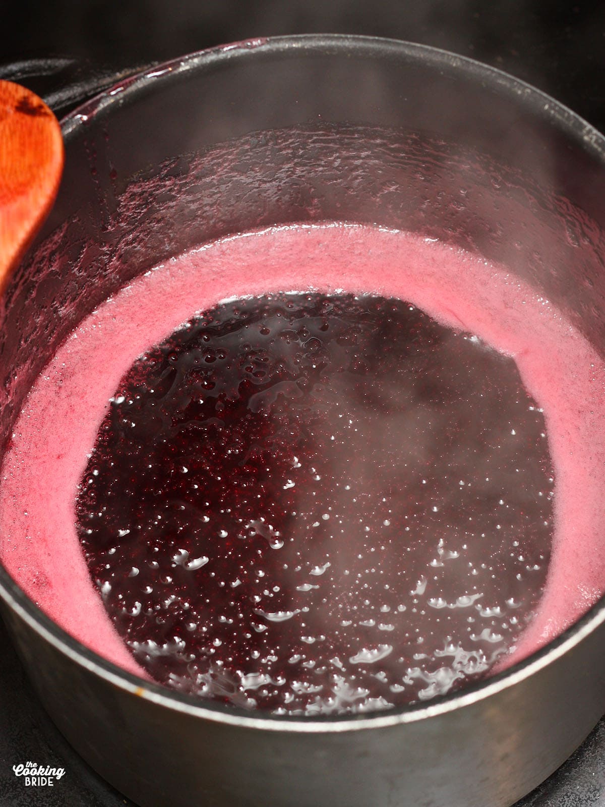 bringing the plum jelly to a boil