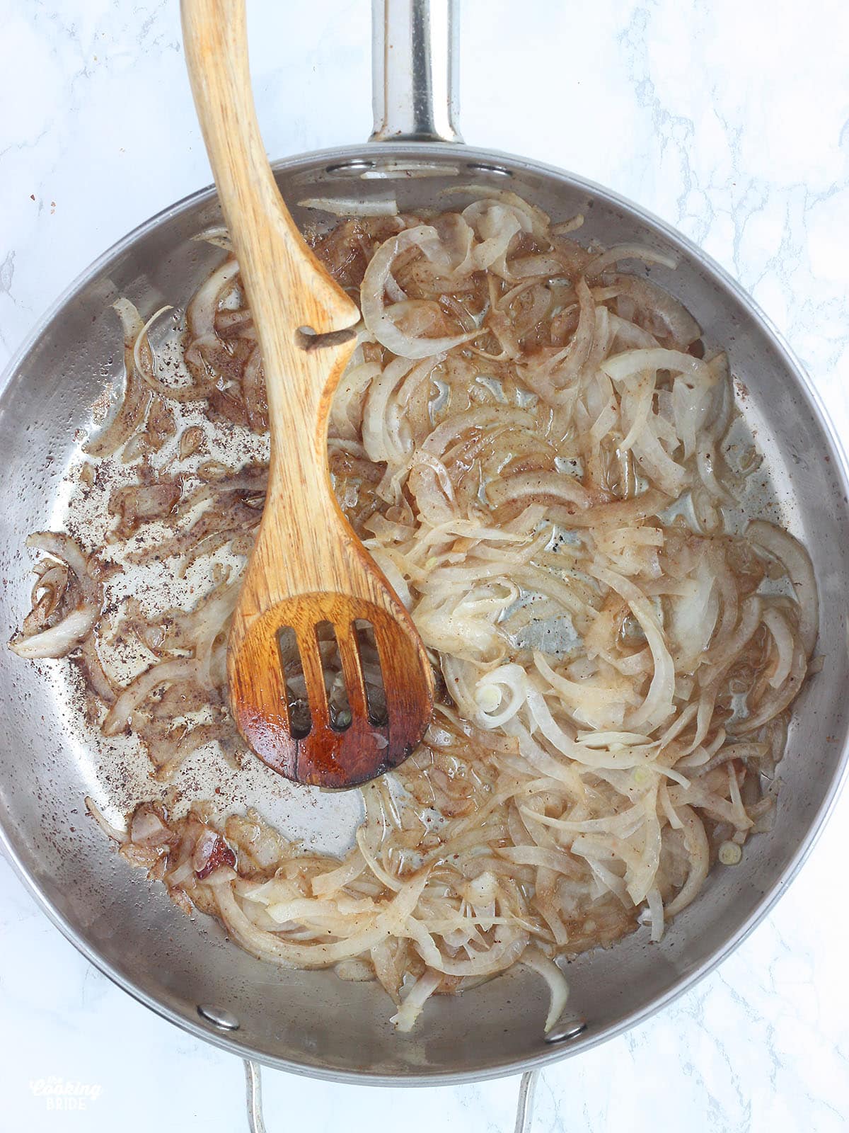 cooking thinly sliced onions in a stainless steel skillet