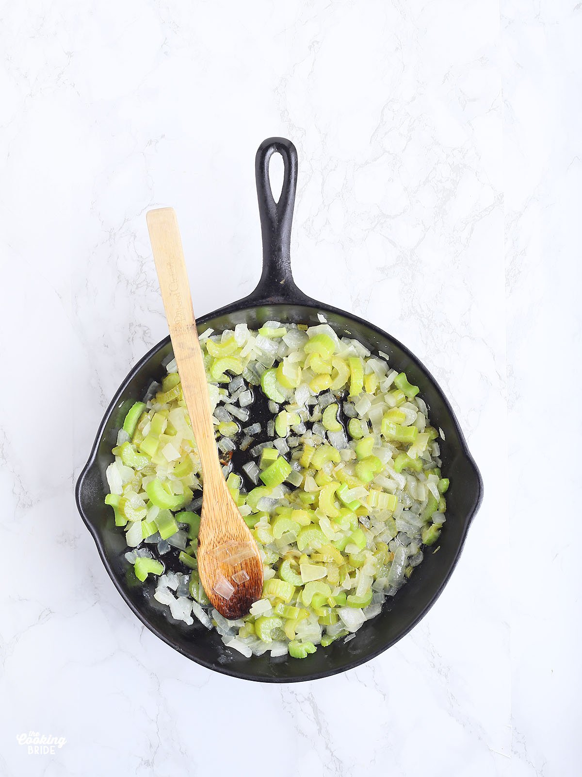 sauteeing onions and celery in a skillet with butter