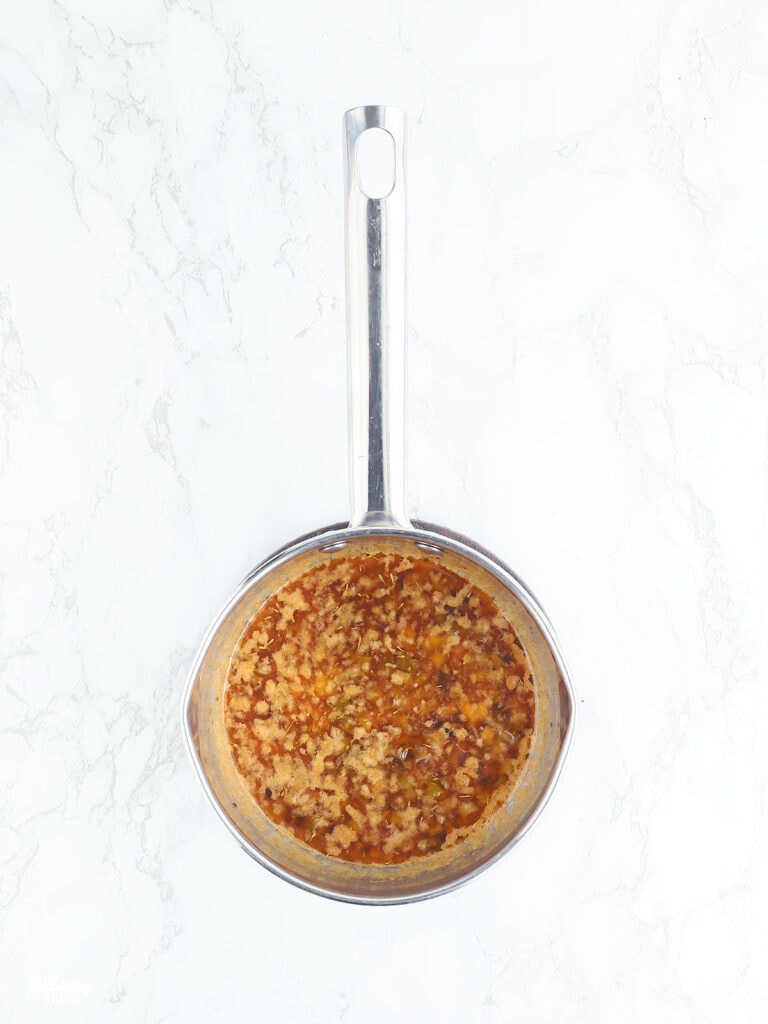 garlic butter sauce in a stainless steel saucepan