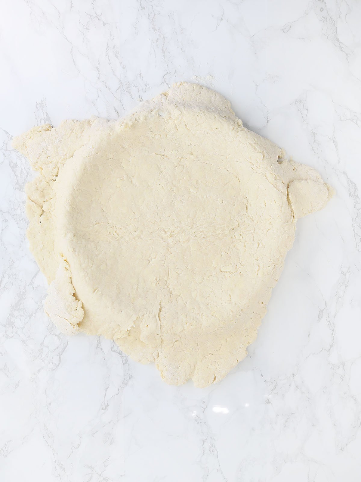 biscuit dough draped over a tart pan
