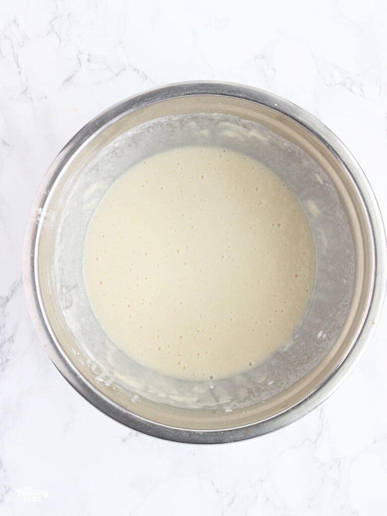 mixed cobbler batter in a stainless steel mixing bowl