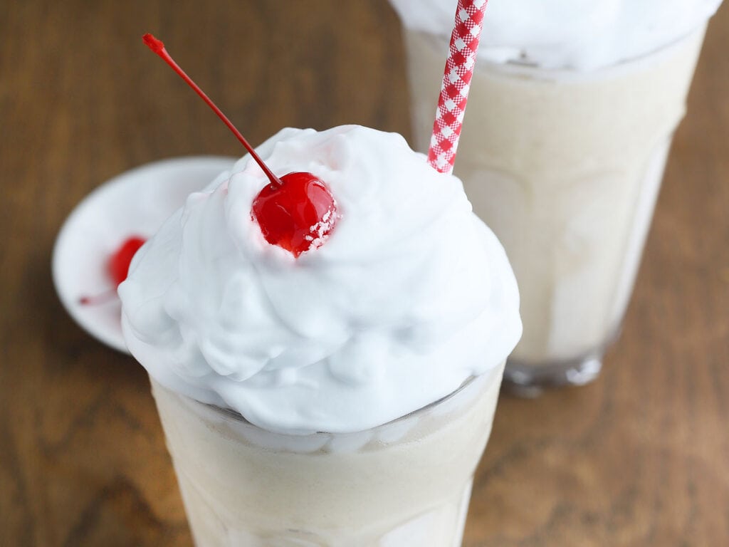 frozen bushwacker cocktail topped with whipped cream and a cherry
