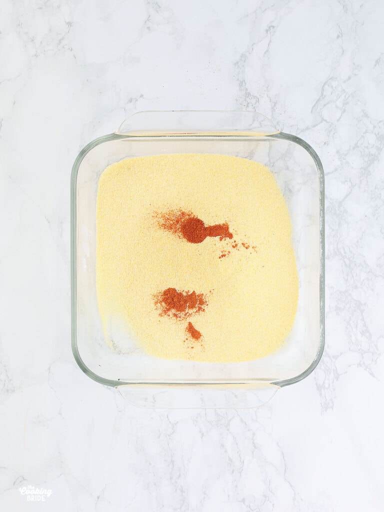 cornmeal and paprika in a glass dish