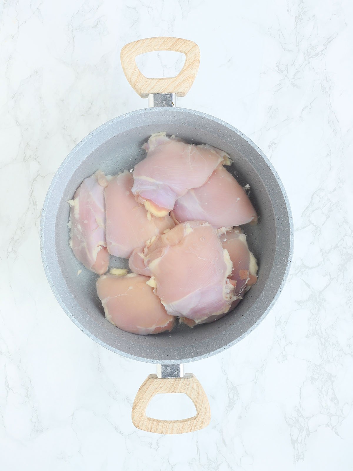 chicken breasts in water in a large pot