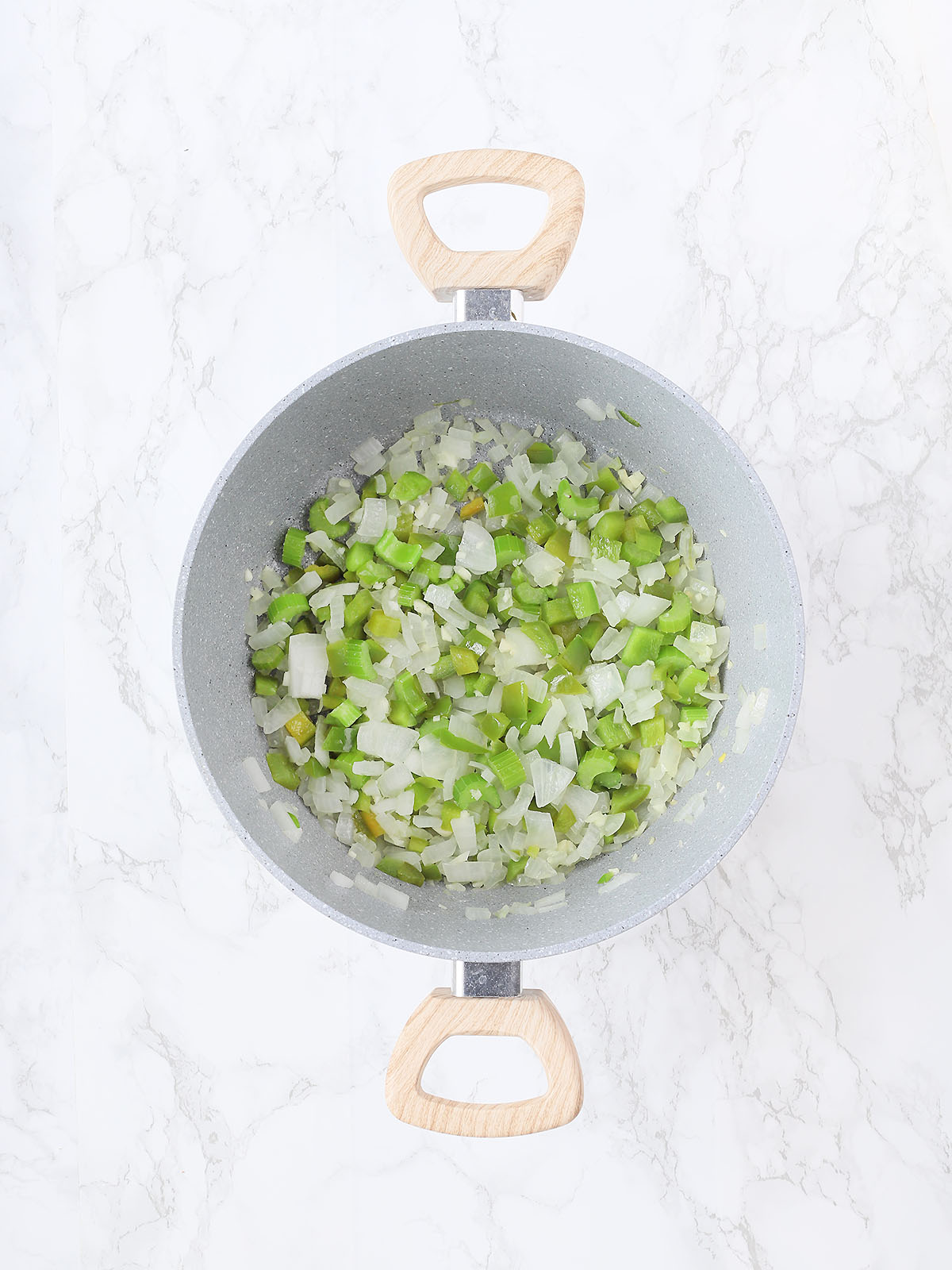 gray pot with diced bell peppers, onions and celery