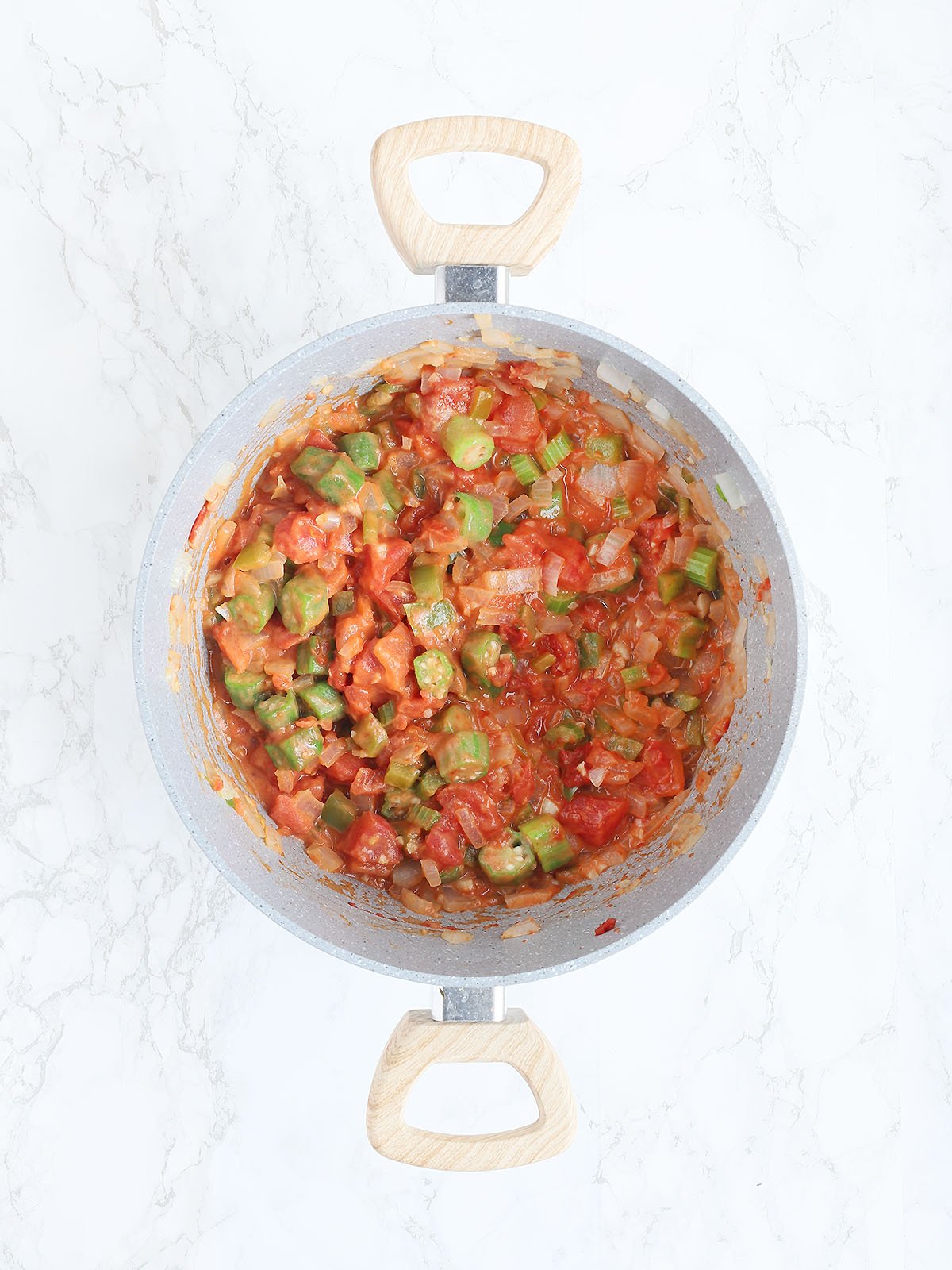 gray pot with sautéed vegetables, diced tomatoes and tomato sauce