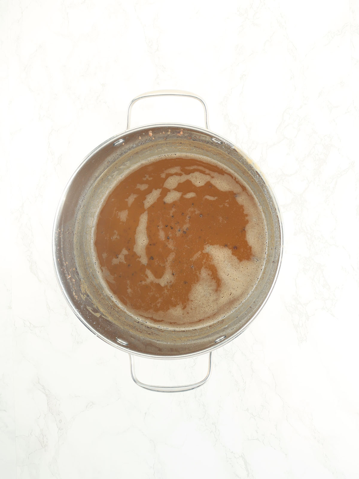 peanut butter colored roux in a large stainless steel stock pot