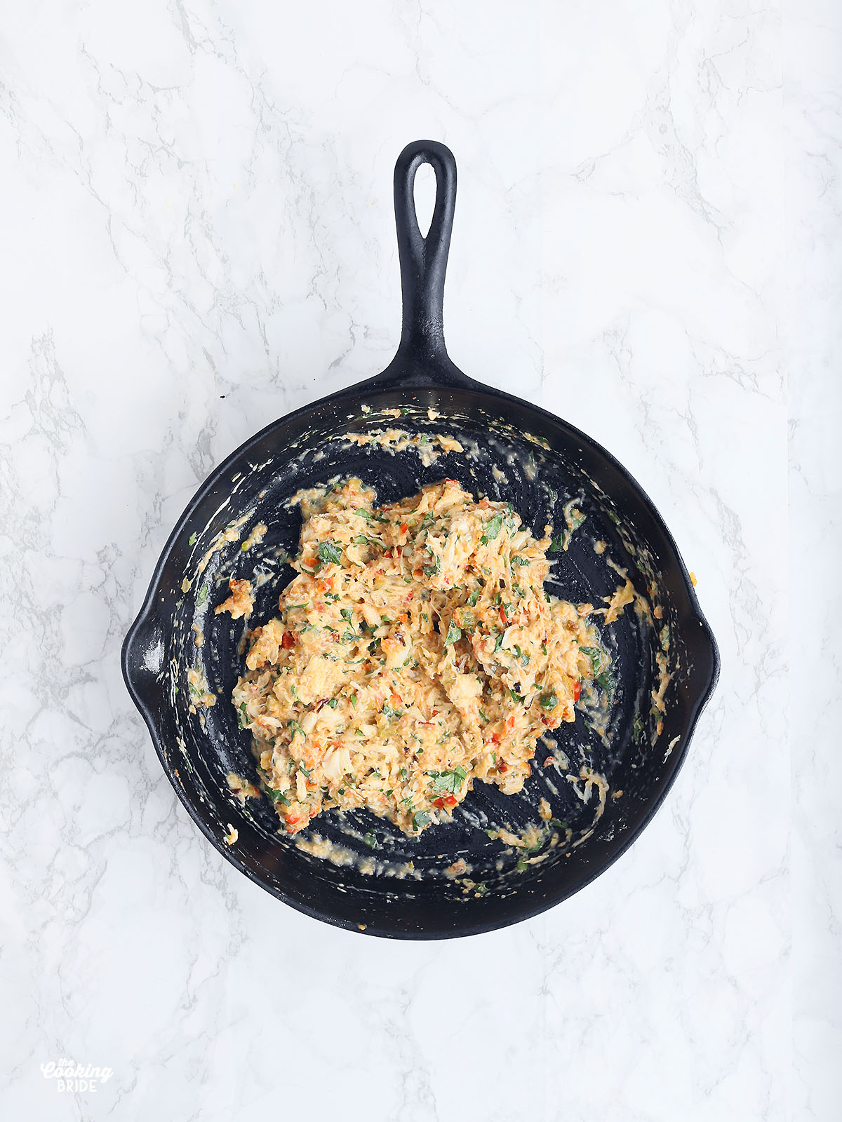 crab meat mixture in a cast iron skillet