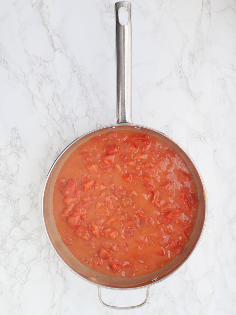 overhead shot of a stainless steel pan of finished tomato gravy