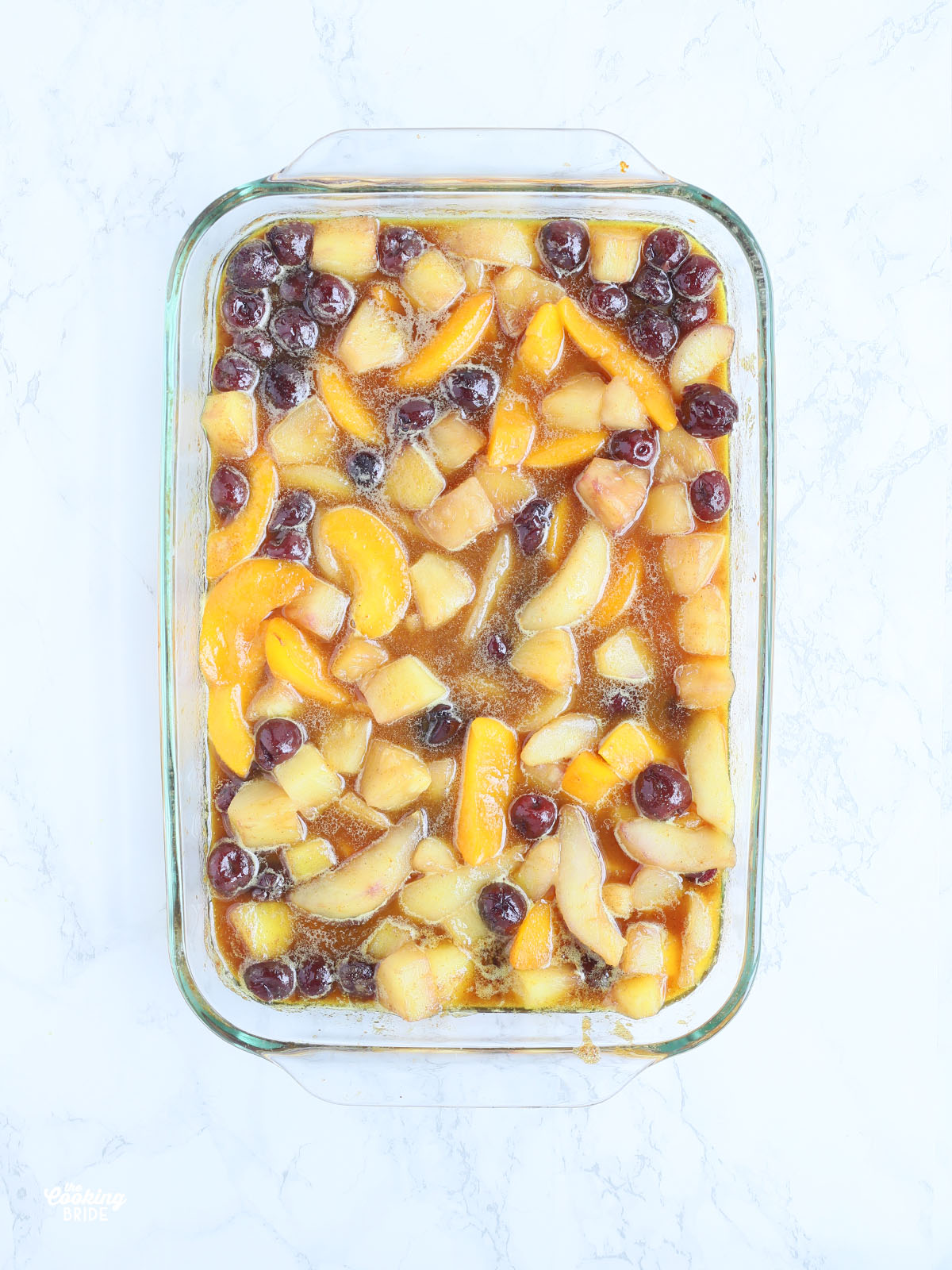 baked hot curried fruit in a glass casserole dish