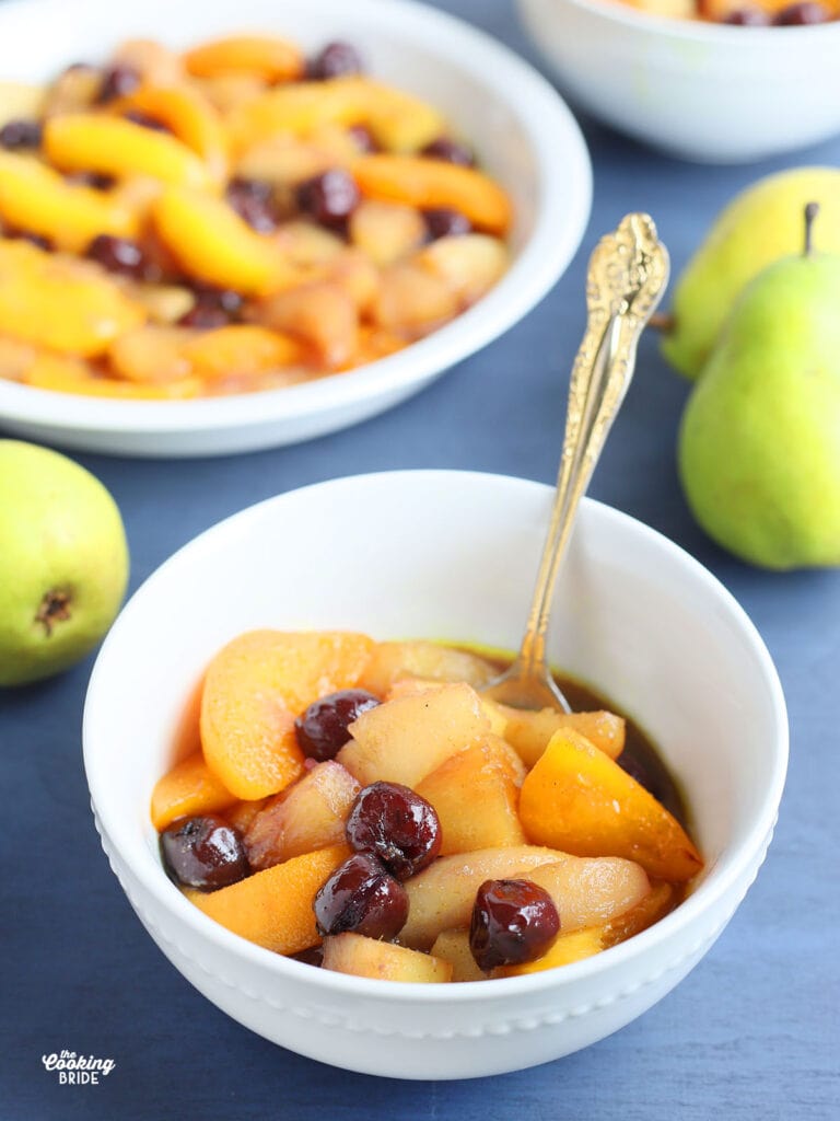 serving of hot curried fruit in a white bowl on a blue background
