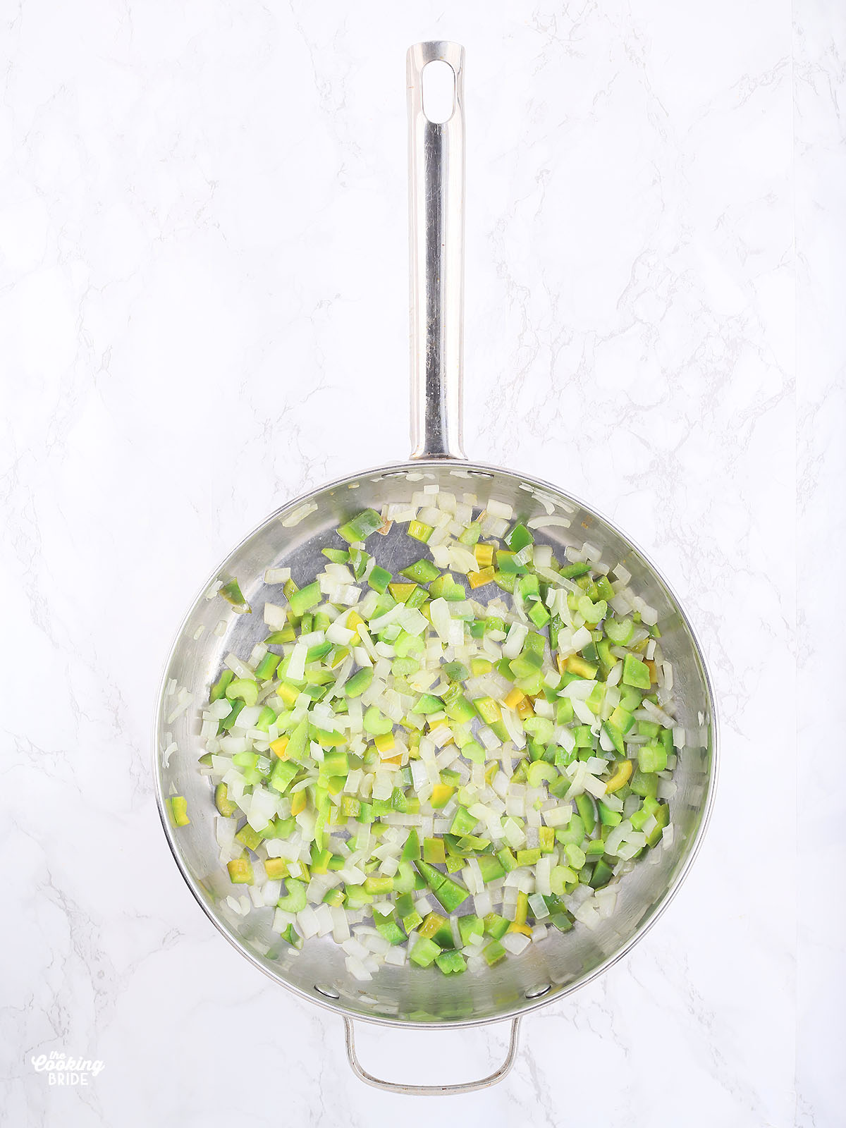 diced green bell peppers, celery and onions sautéing in melted butter