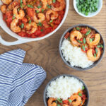 two servings of shrimp creole with rice in gray serving bowls