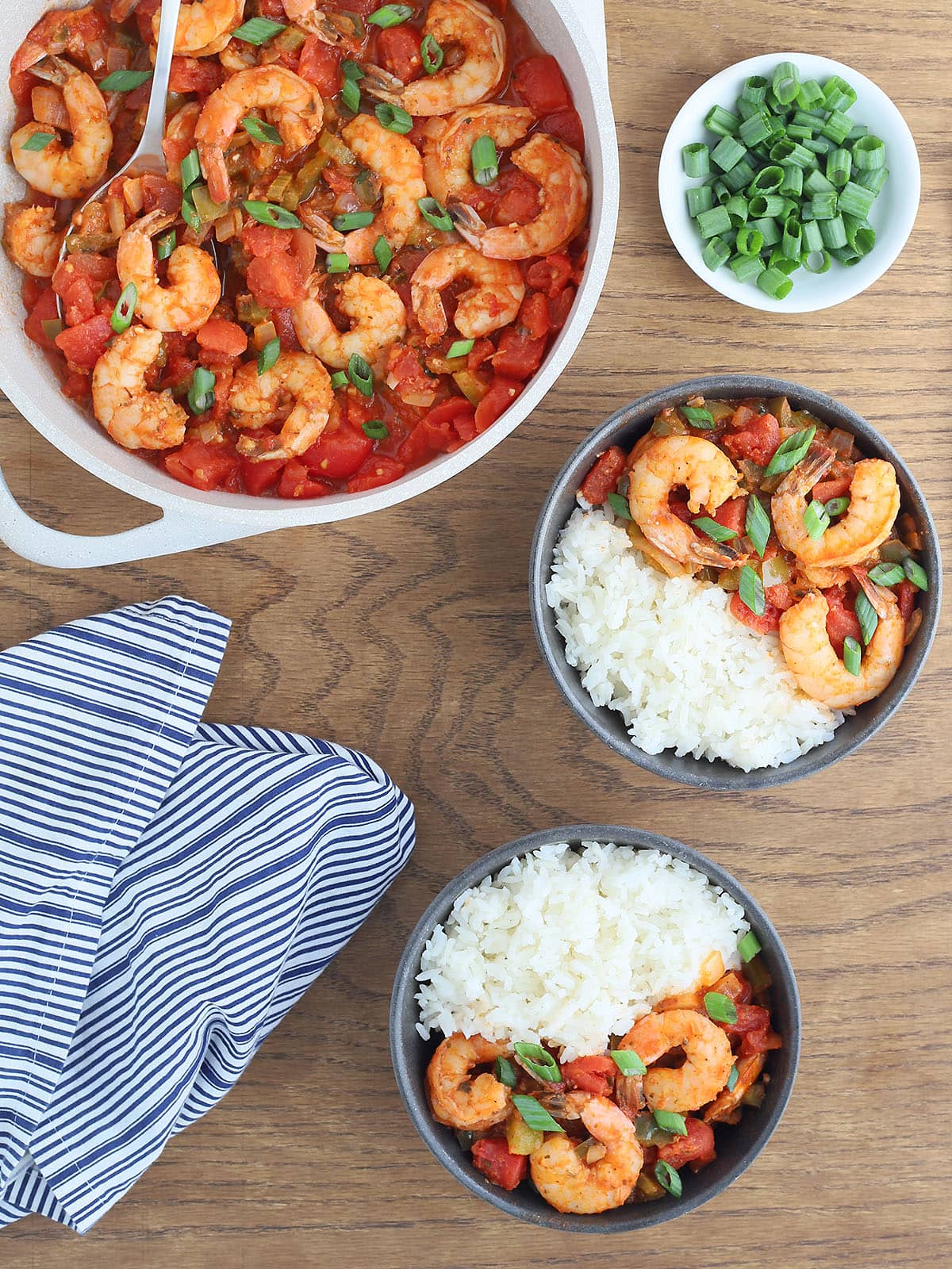 two servings of shrimp creole with rice in gray serving bowls