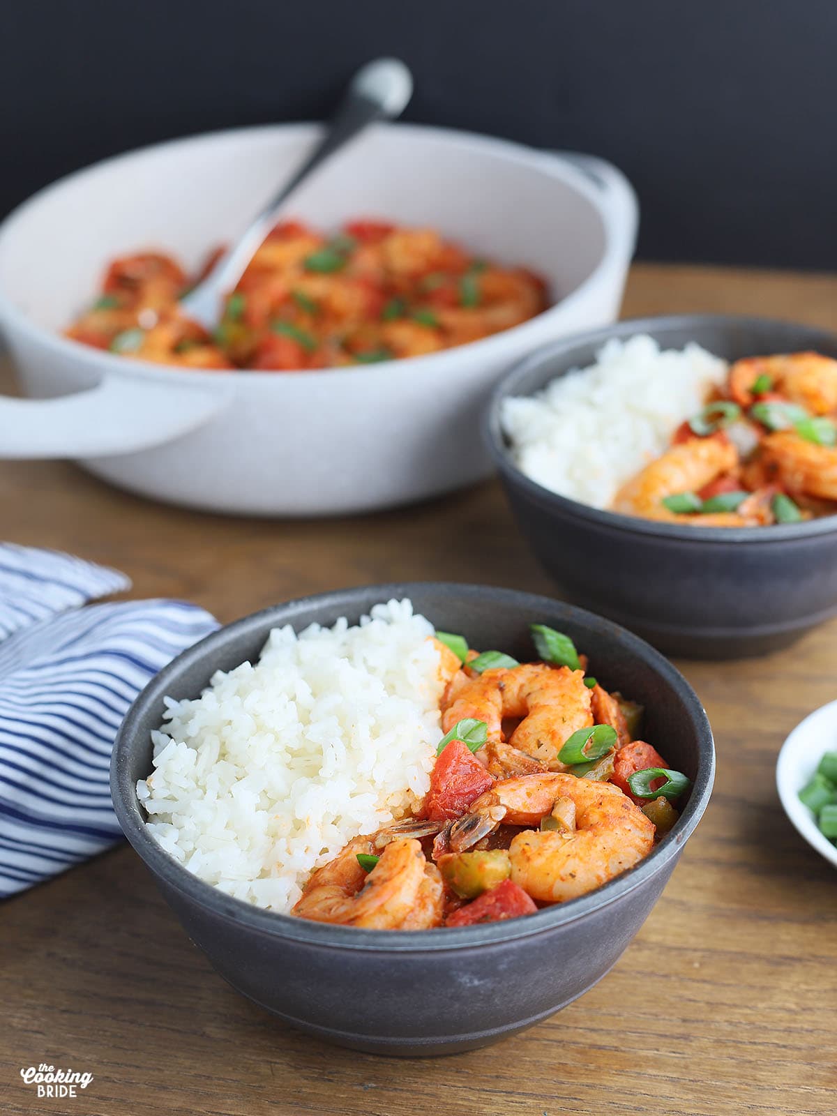 individual serving of shrimp creole and rice in a gray serving bowl
