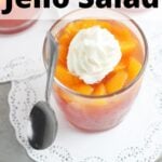 individual serving of peach jello salad topped with whipped cream