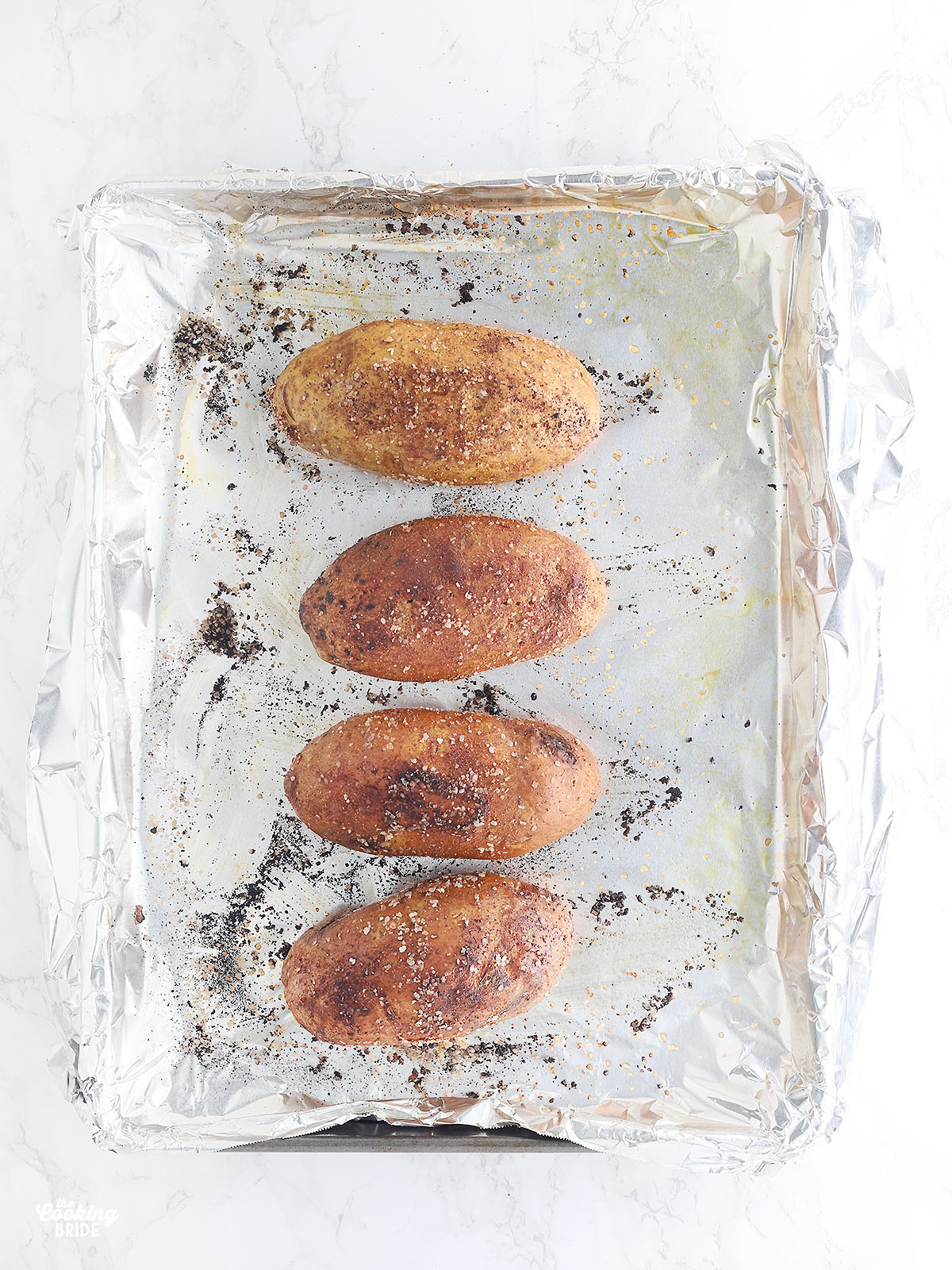 baked Russet potatoes on a foil lined baking sheet
