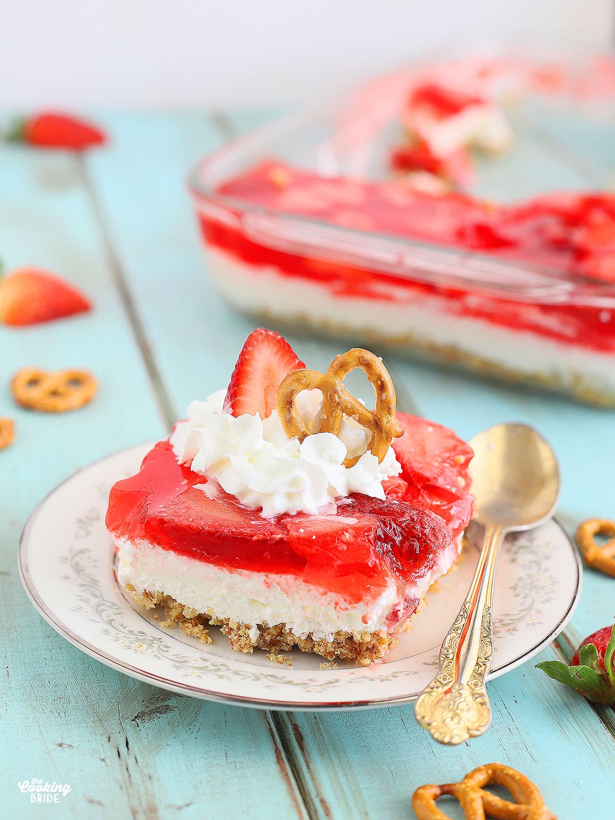 one serving of strawberry pretzel salad on a plate garnished with whipped cream