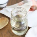 mason jar full of simple syrup with sugar and water in the background