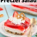 one serving of strawberry pretzel salad on a plate garnished with whipped cream