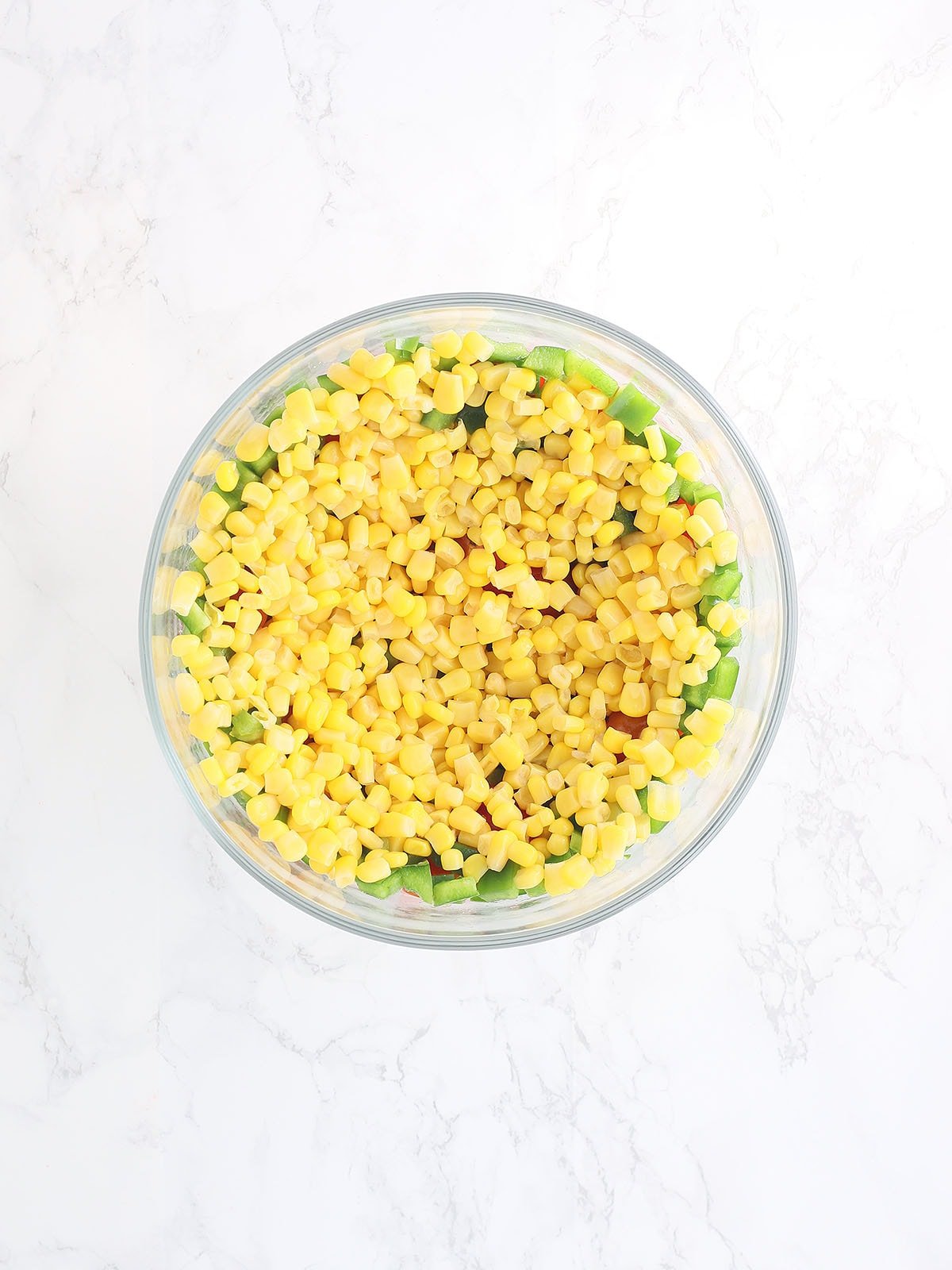 cornbread salad topped with whole kernel corn