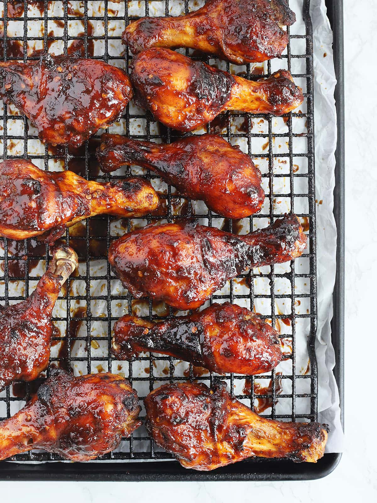 baked honey chipotle chicken drumsticks on a baking sheet
