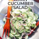 asian cucumber salad in a blue serving bowl