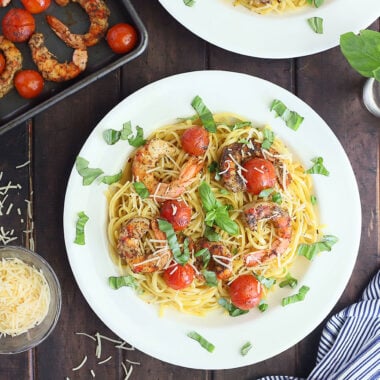 royal red shrimp and cherry tomatoes garnished with fresh basil over linguine