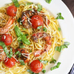 royal red shrimp and cherry tomatoes garnished with fresh basil over linguine