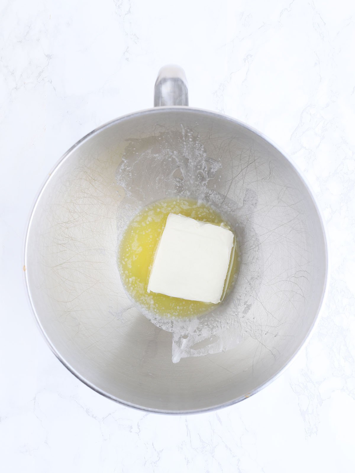 melted butter and cream cheese in a metal mixing bowl