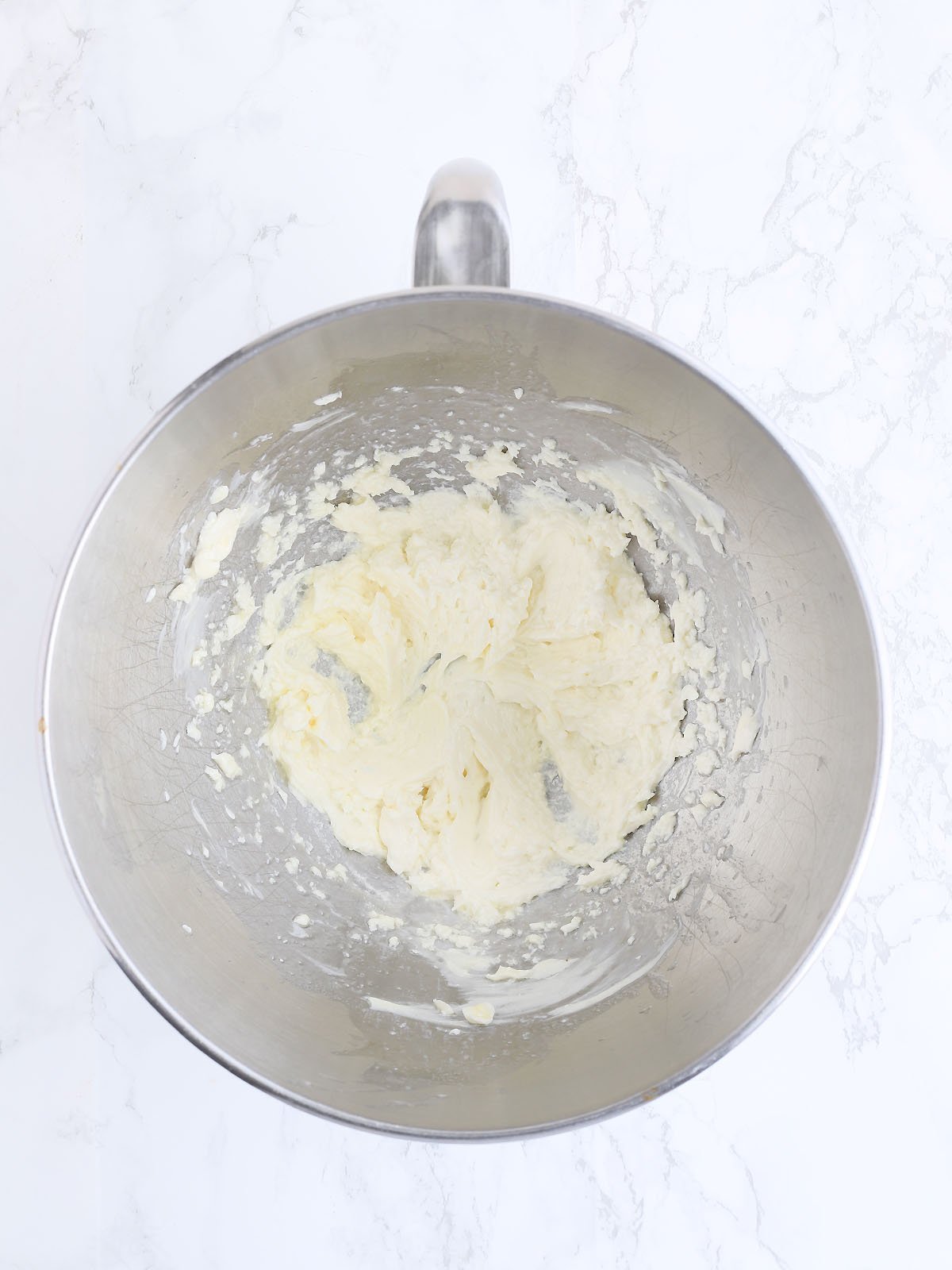 melted butter and cream cheese whipped together in a metal mixing bowl