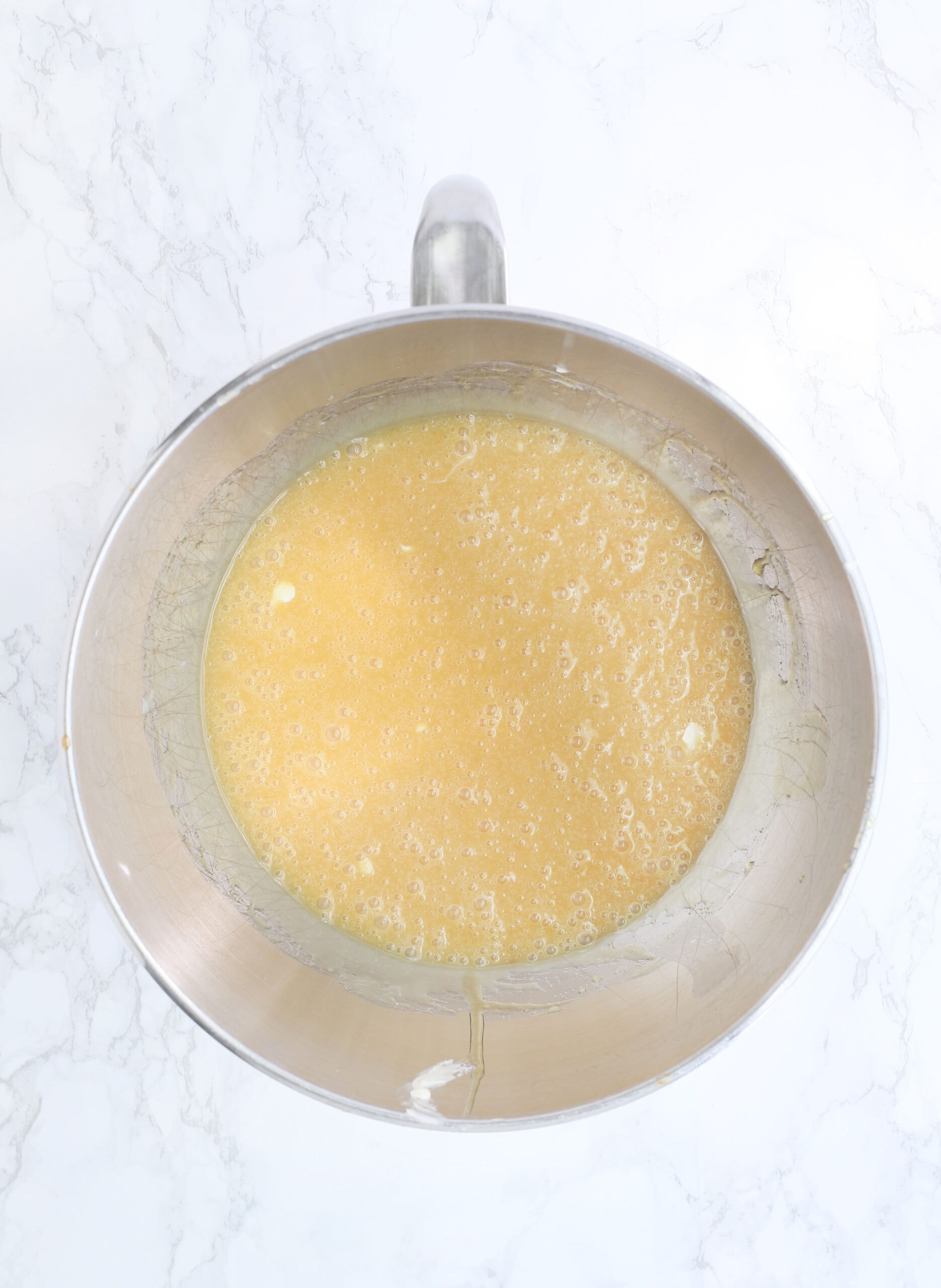 creamed honey and butter in a metal mixing bowl