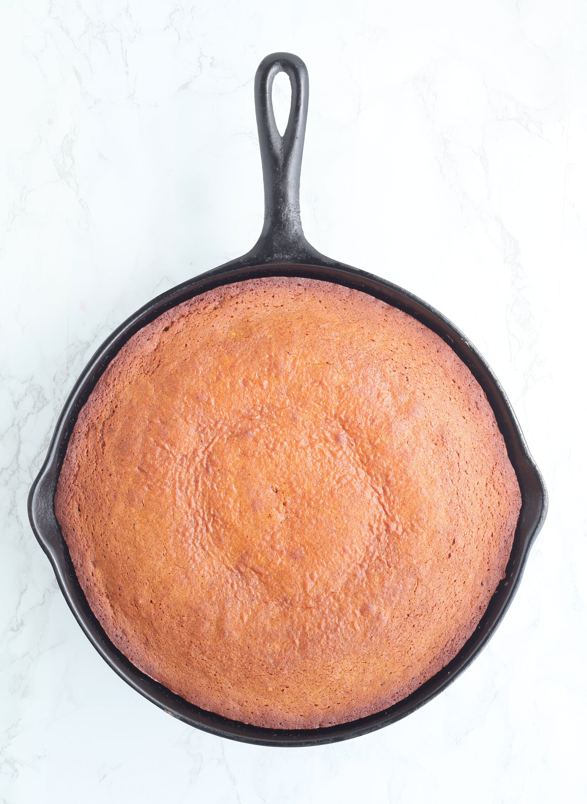 baked honey cake in a cast iron skillet right out of the oven