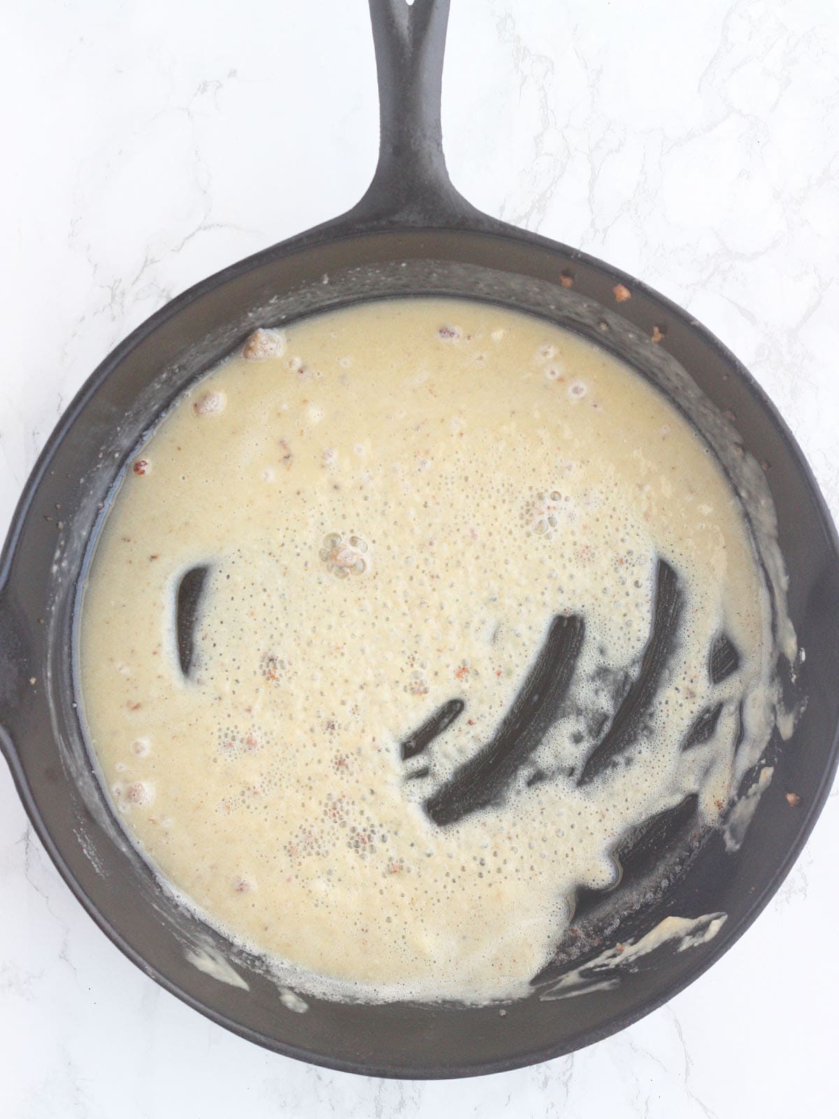 making of a roux in a cast iron skillet.