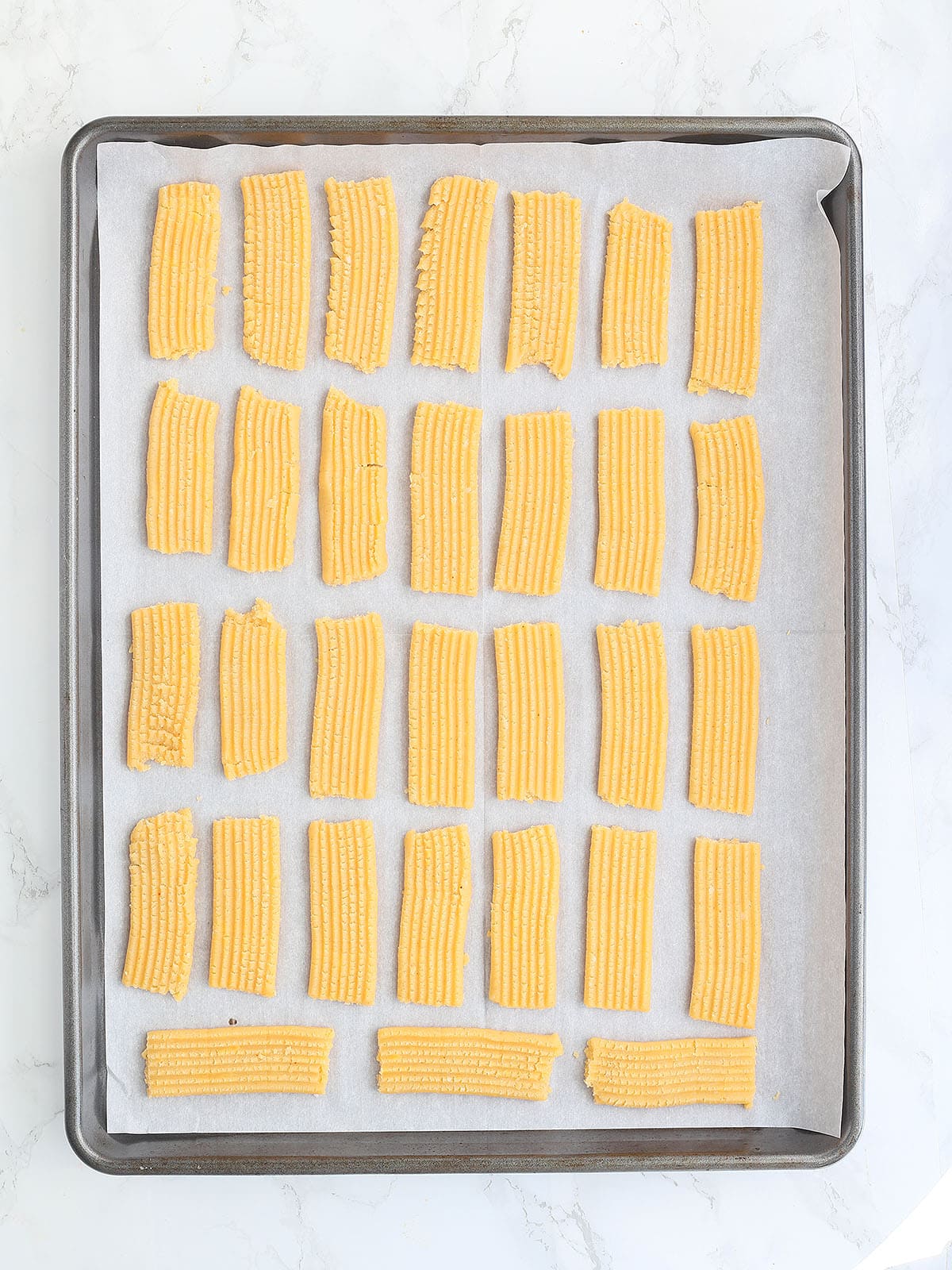 unbaked cheese straw dough on a baking sheet.