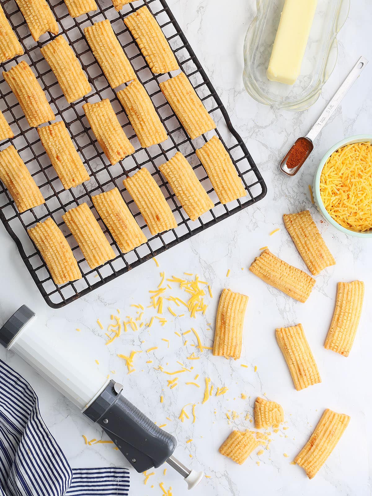 baked cheese straws cooking on a wire rack