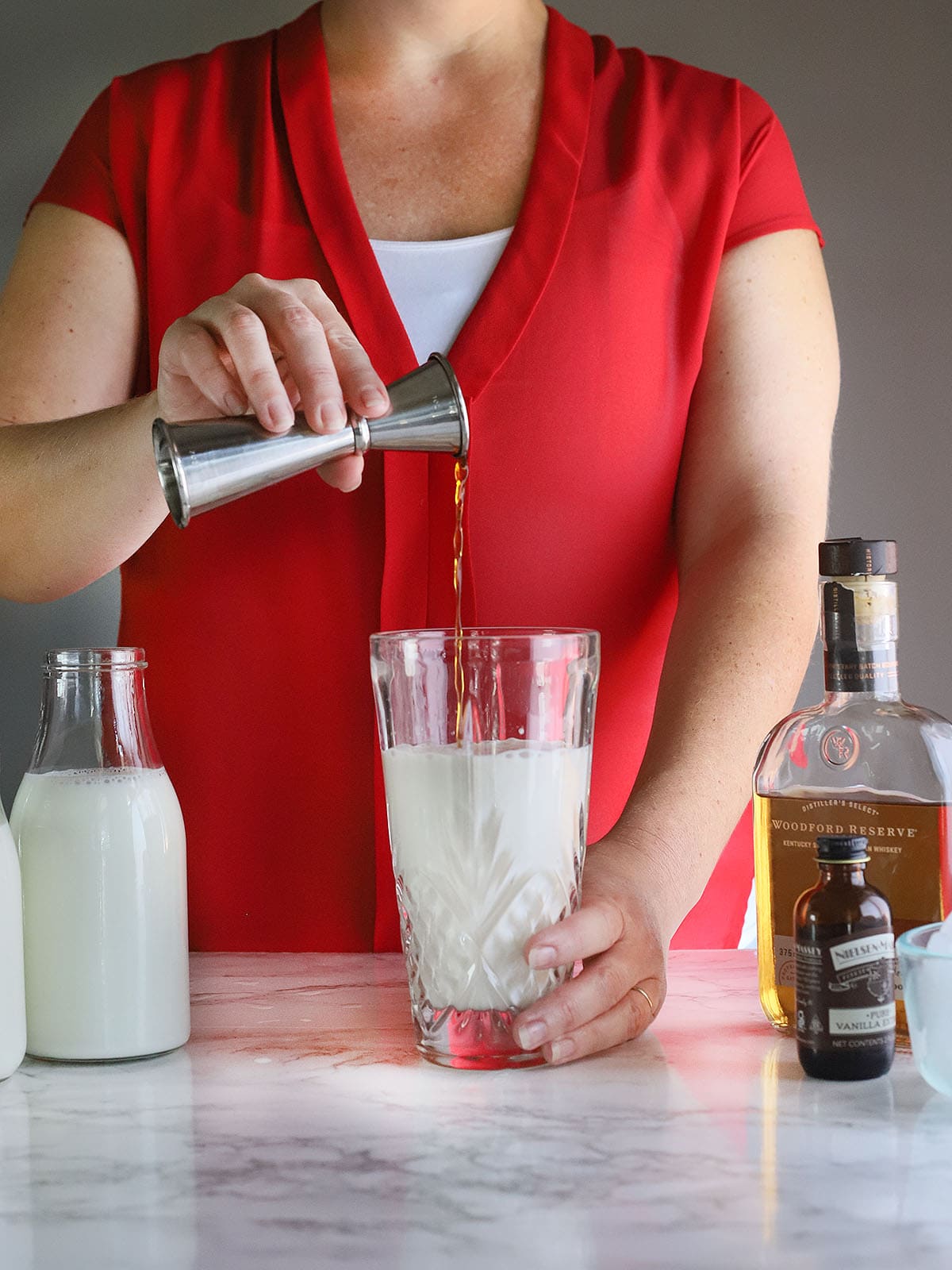 pouring vanilla into a cocktail shaker