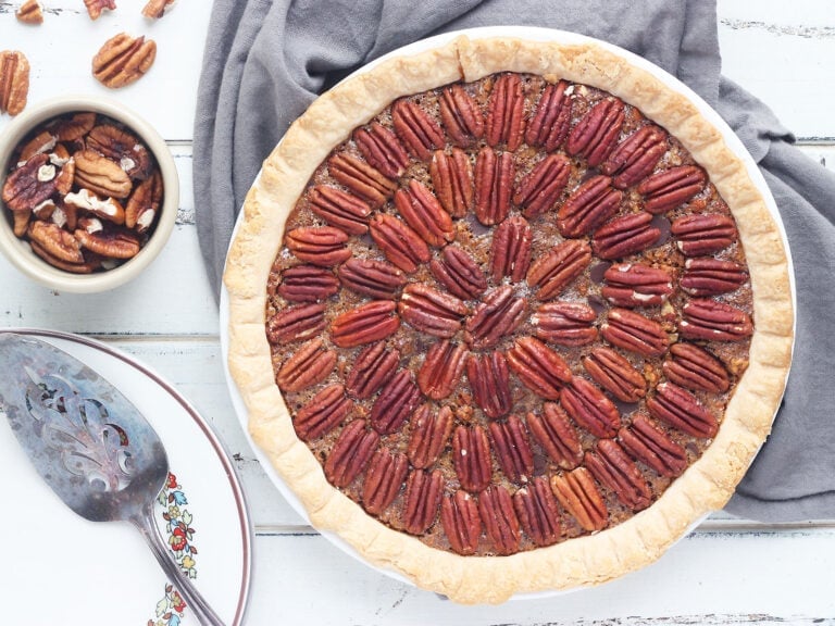 whole chocolate chip pecan pie on a gray napkin