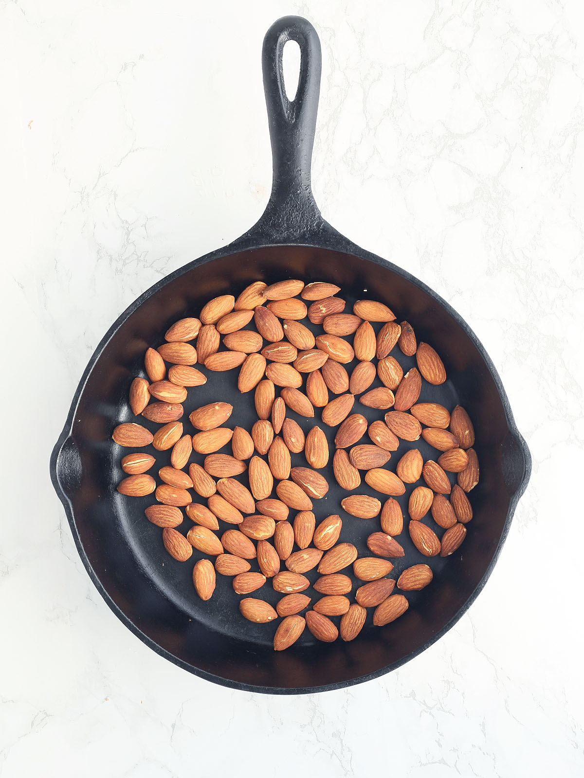 toasted almonds in a cast iron skillet