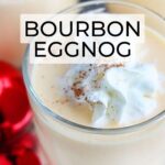 glass of bourbon eggnog garnished with whipped cream and nutmeg