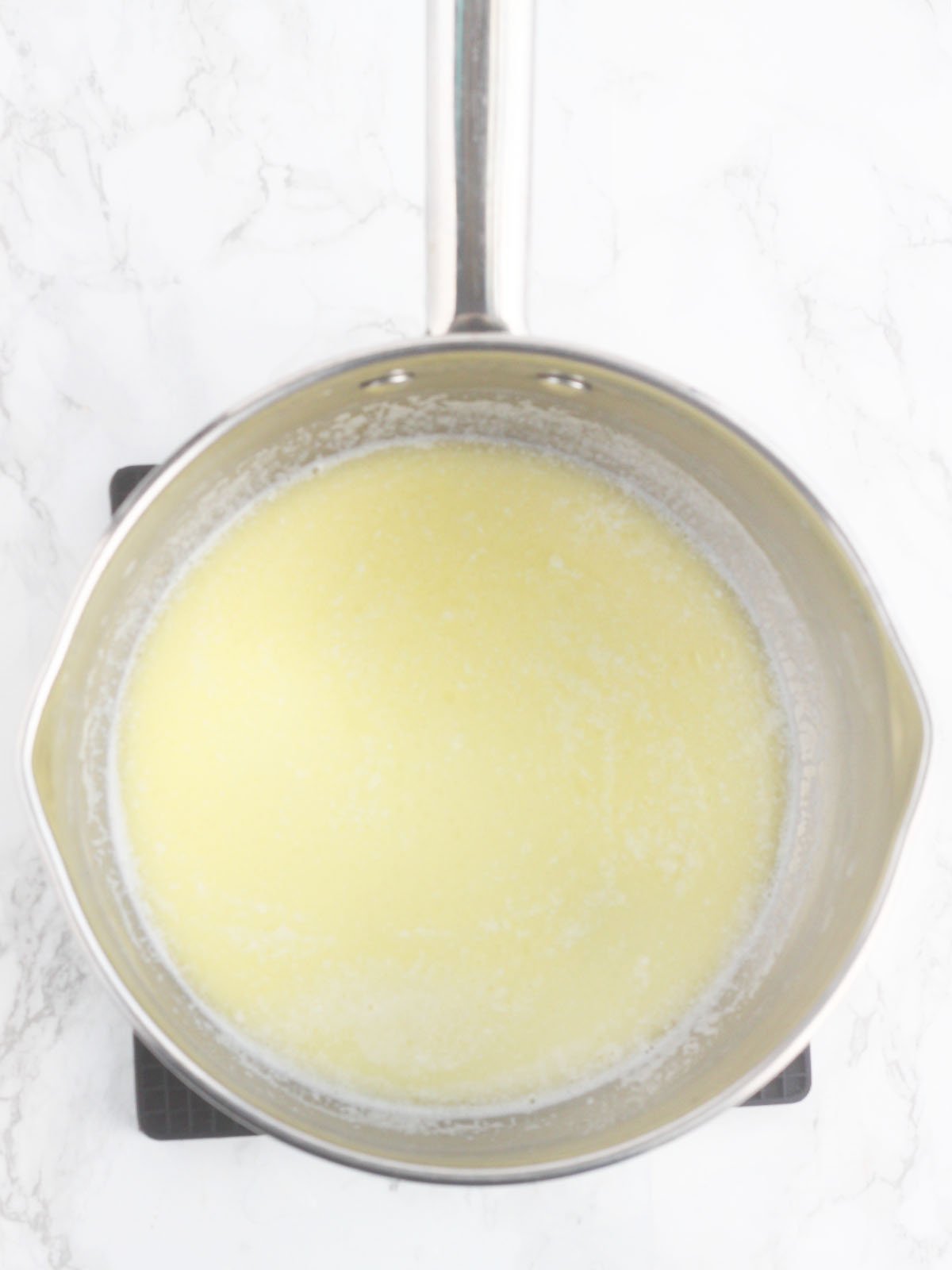 melted butter and warm milk in a metal pan