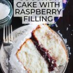 one slice of easy coconut cake with raspberry filling on a plate with a fork on the side