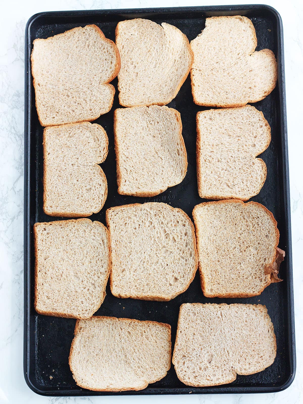 sliced of bread arranged on a baking sheet
