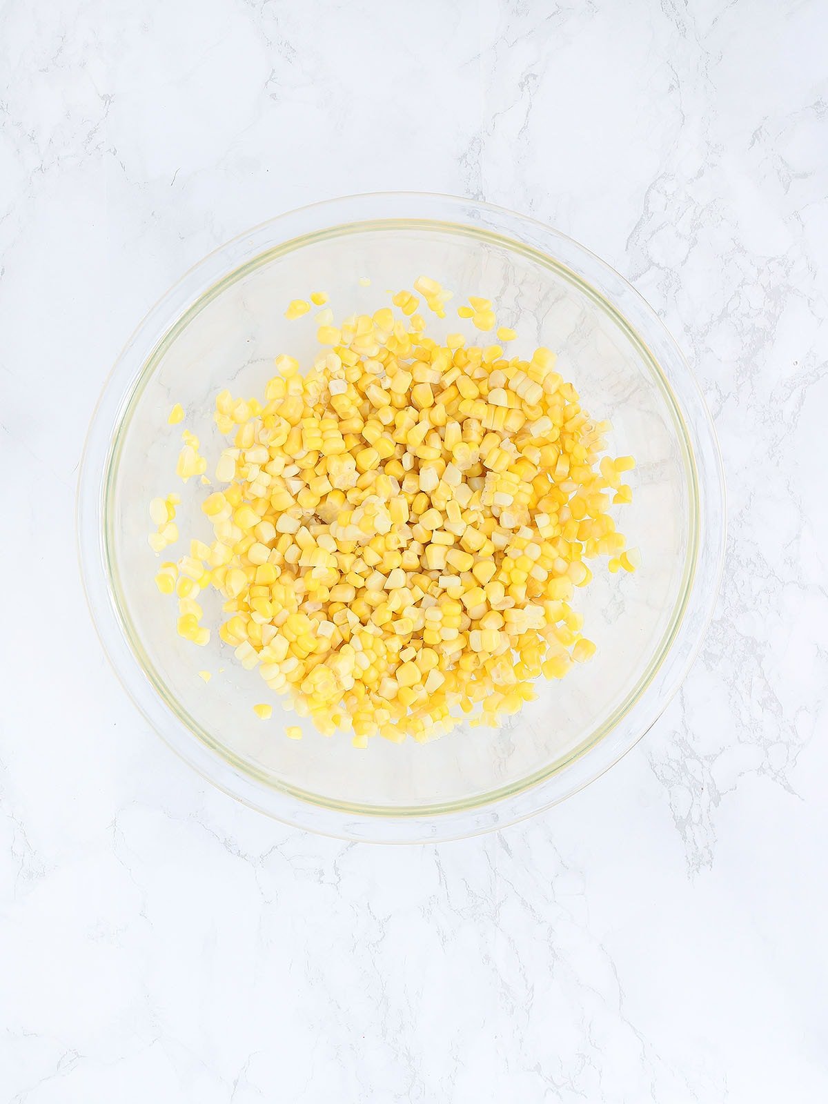 corn kernels in a large glass mixing bowl