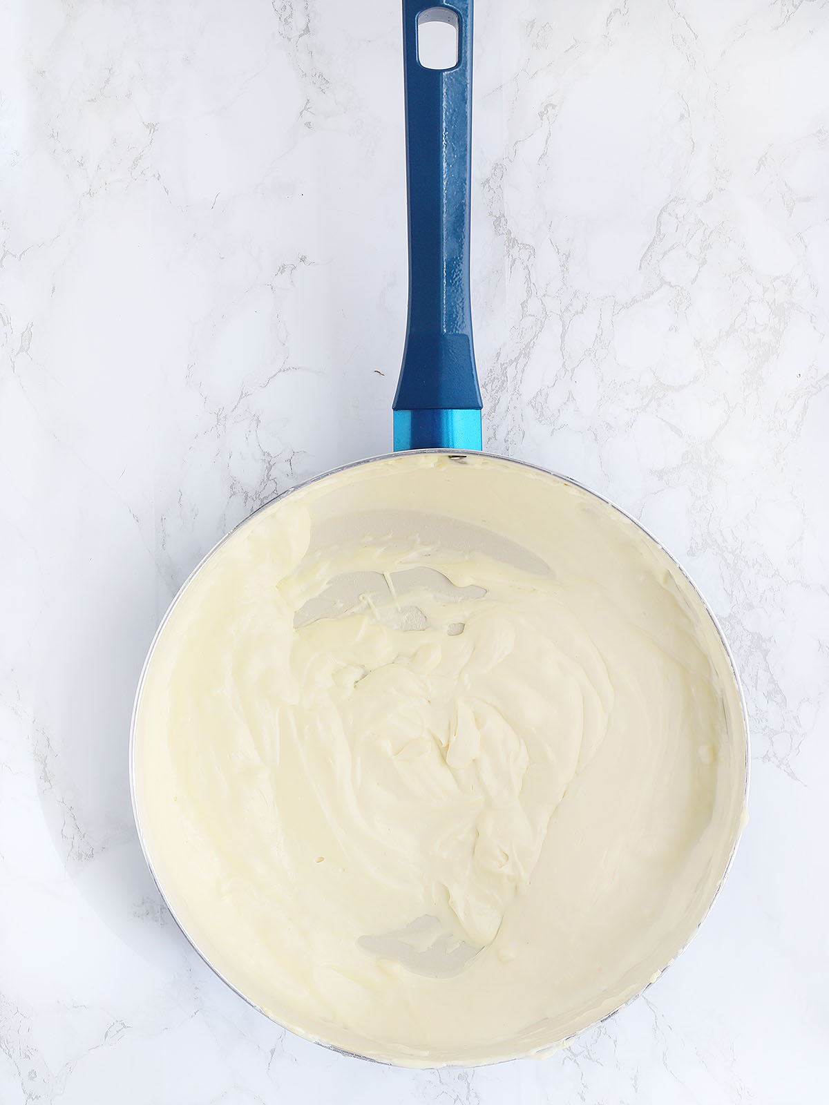 cream cheese, mayonnaise and sour cream melted in a large blue skillet