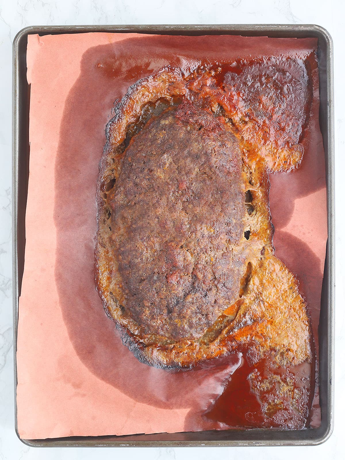 Baked meatloaf on a sheet pan.
