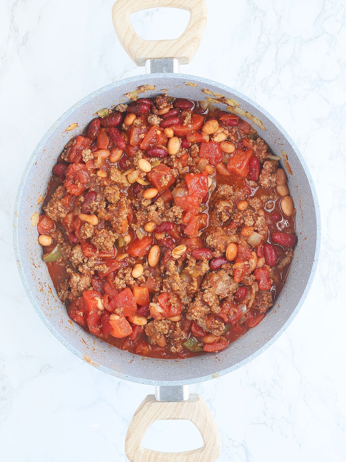 Ground beef, vegetables beans and diced tomatoes in a large stock pot.